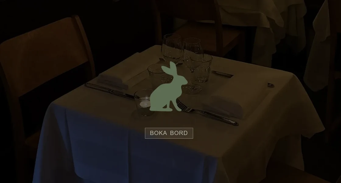 Harpaviljongen start page: a set table in a dim dining room with a green rabbit logo and a Boka bord (book a table) button